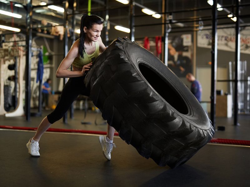 woman-flipping-truck-tire-in-gym-2023-11-27-05-18-30-utc